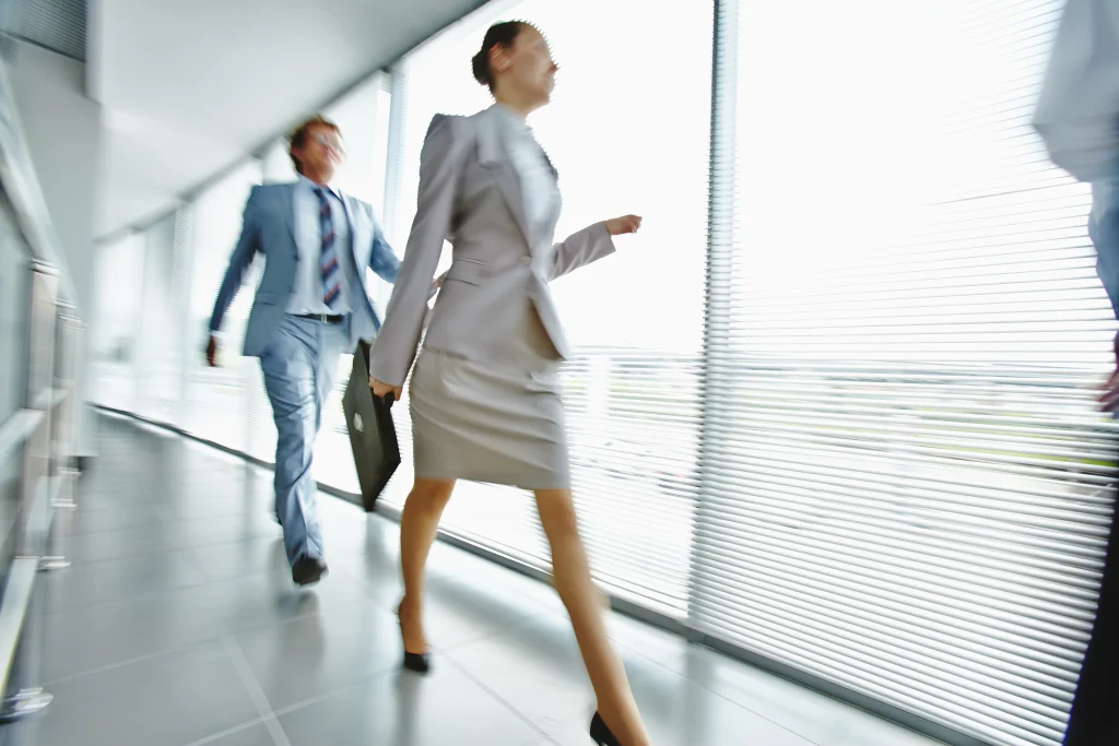 businesspeople walking through corridor