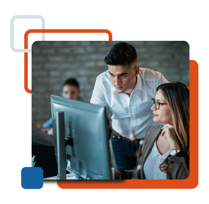 two coworkers staring at a monitor