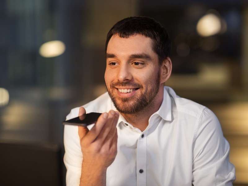 man in a white shirt speaking on the phone