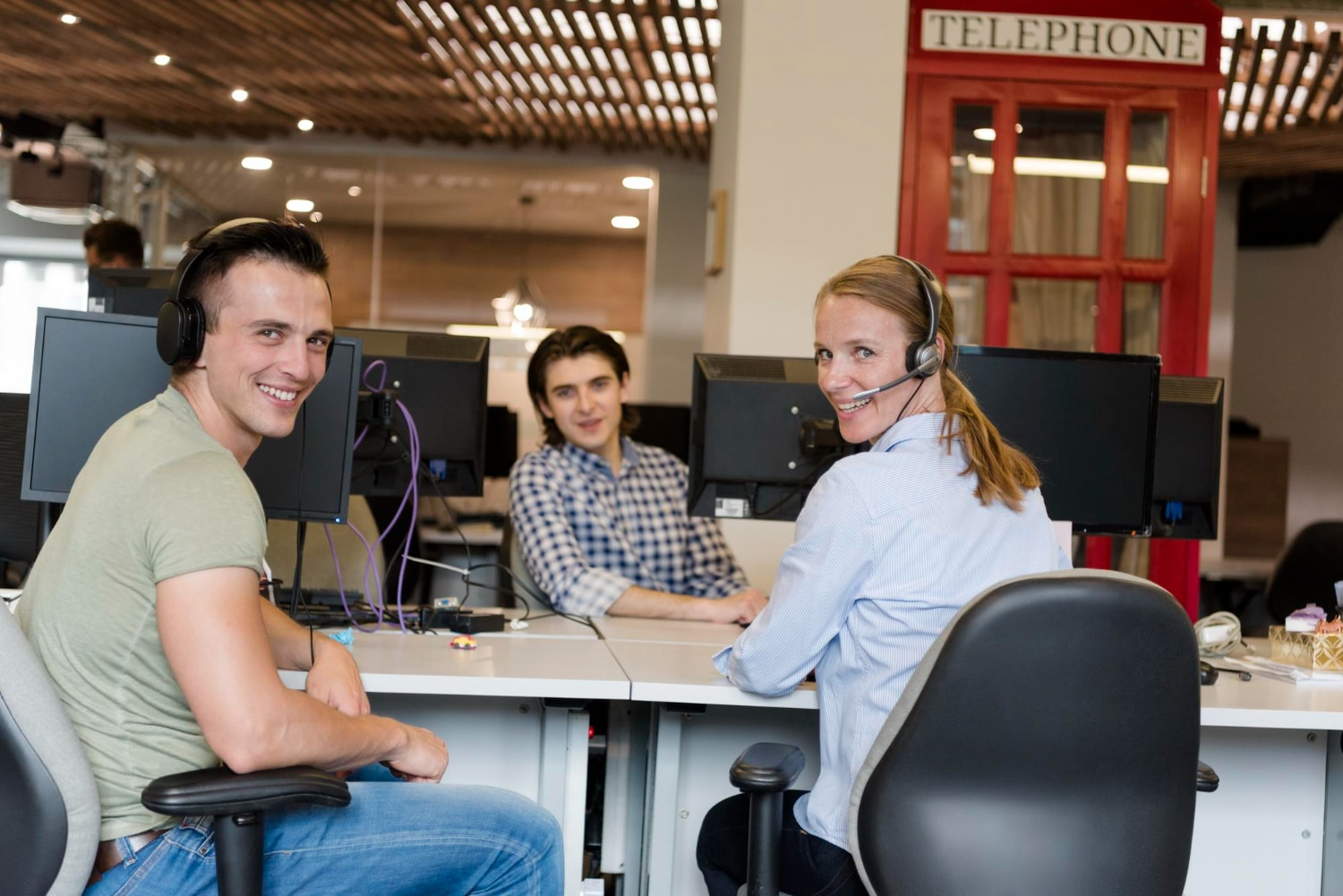 Call center team uses cloud PBX systems provided by trusted cloud PBX providers, demonstrating efficient and engaging cloud communications in a modern workspace.